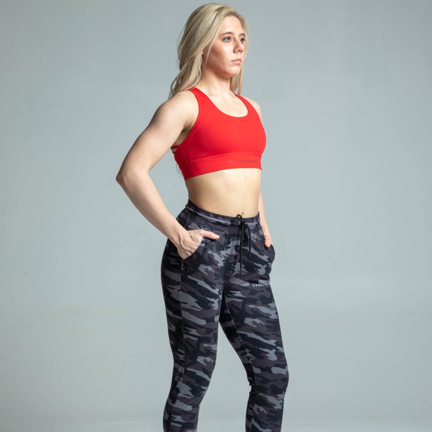 Angled view of woman wearing red cross-back sports bra