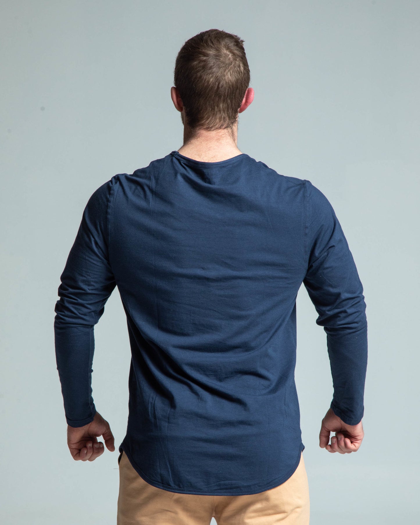 Back view of man wearing navy long sleeve tee