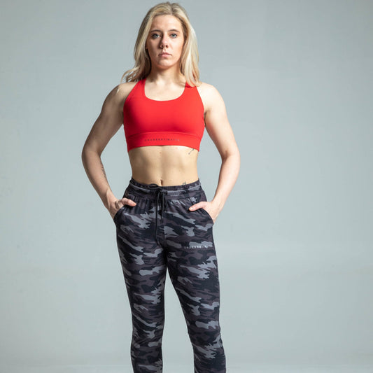 Front view of woman wearing red cross-back sports bra