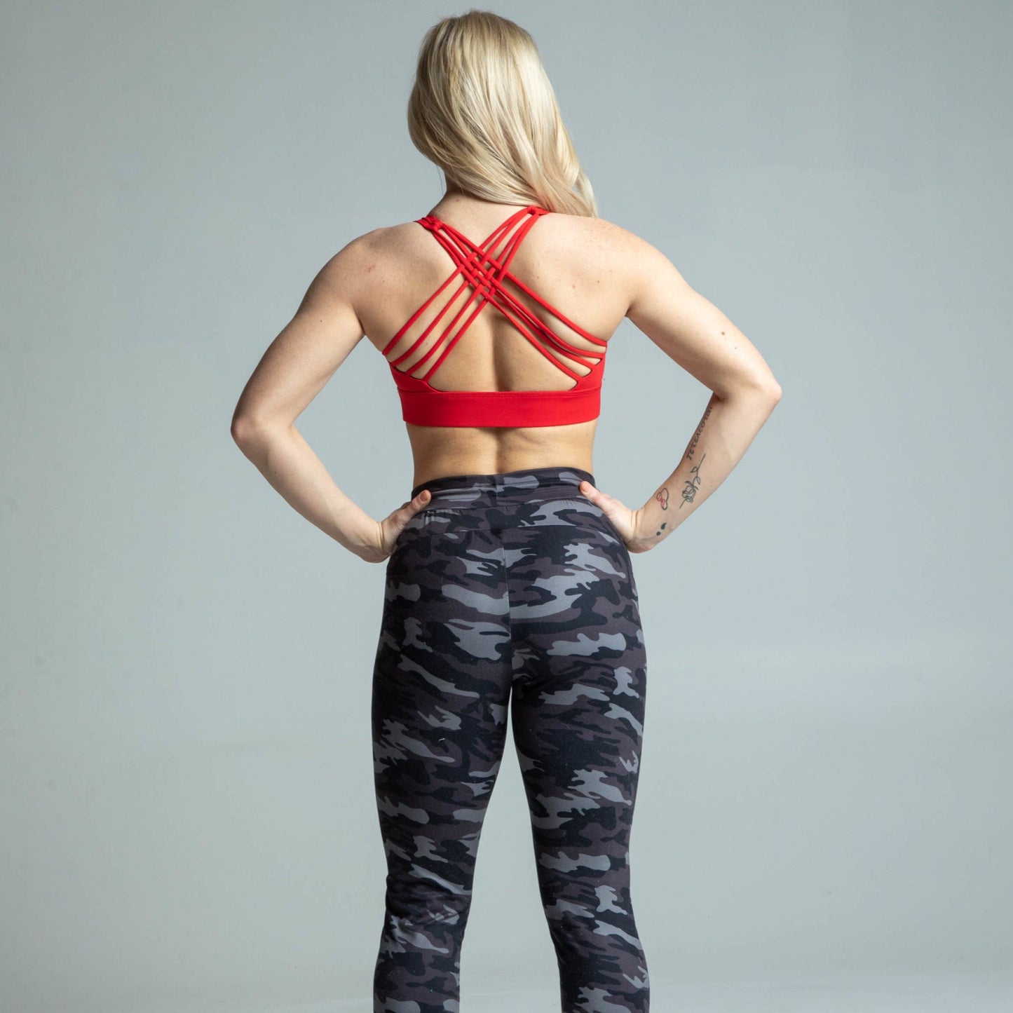 Back view of woman wearing red cross-back sports bra
